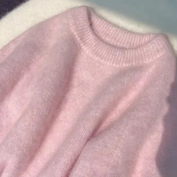 Close-up of a pink sweater with a blurred background